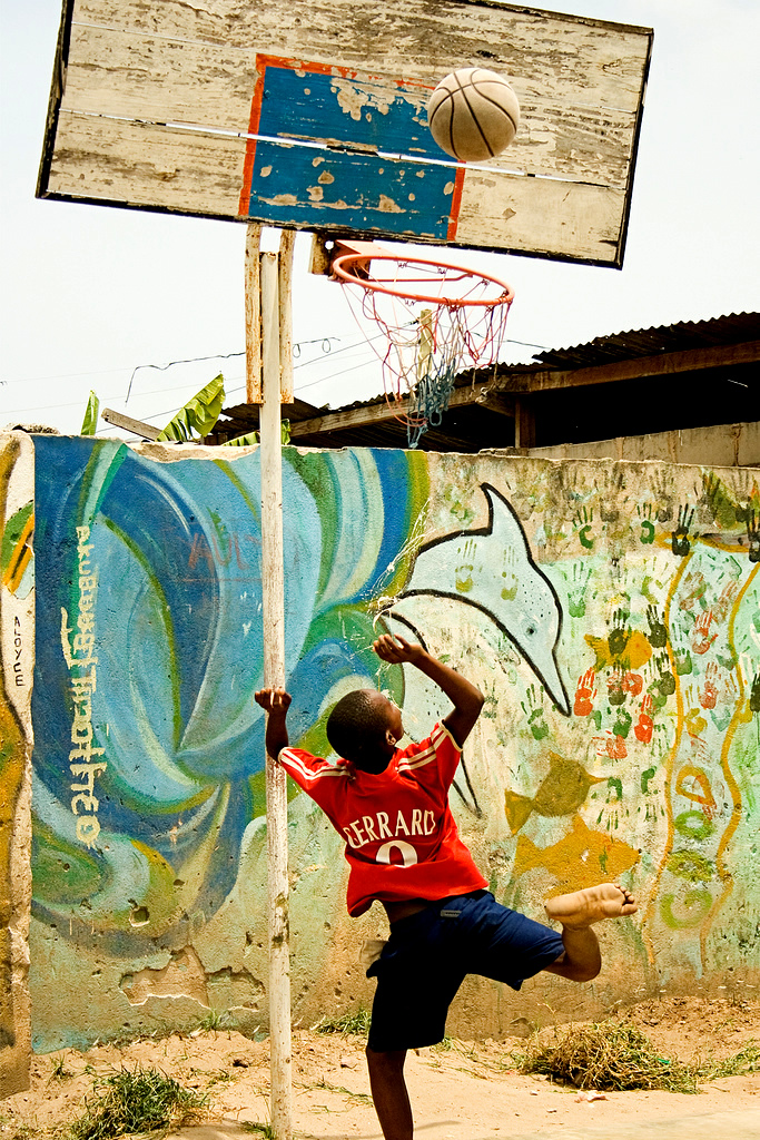 Tanzanian child playing basketball.